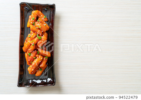deep fried Korean rice cake (Tteokbokki) skewered with spicy sauce 94522479