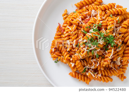 spirali or spiral pasta with tomato sauce 94522480