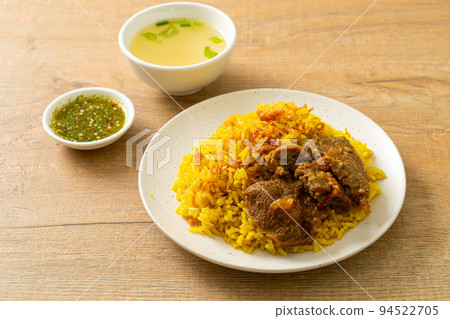 Beef Biryani or Curried rice and beef - Thai-Muslim version of Indian biryani, with fragrant yellow rice and beef Beef Biryani or Curried rice and beef - Thai-Muslim version of Indian biryani, with fragrant yellow rice and beef 94522705