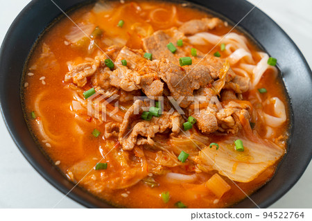 Korean udon ramen noodles with pork in kimchi soup 94522764