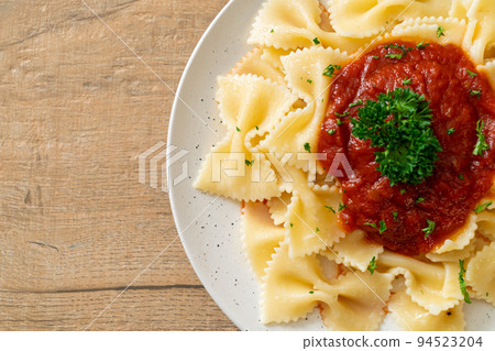 farfalle pasta in tomato sauce with parsley farfalle pasta in tomato sauce with parsley 94523204