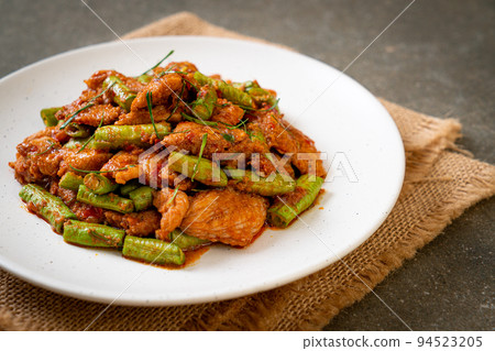Stir fried pork and red curry paste with sting bean Stir fried pork and red curry paste with sting bean 94523205