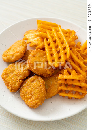 fried chicken nuggets with fried potatoes 94523239