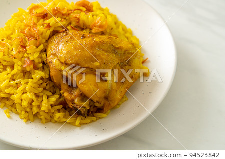 Chicken Biryani or Curried rice and chicken - Thai-Muslim version of Indian biryani, with fragrant yellow rice and chicken Chicken Biryani or Curried rice and chicken - Thai-Muslim version of Indian biryani, with fragrant yellow rice and chicken 94523842