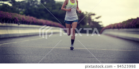 Fitness woman runner running on city bridge road Fitness woman runner running on city bridge road 94523998