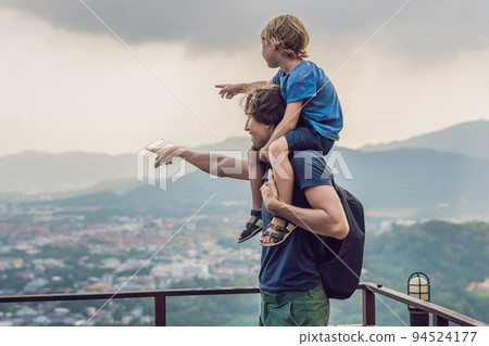 Father and son in the background of Phuket Town view from monkey Hill Father and son in the background of Phuket Town view from monkey Hill 94524177