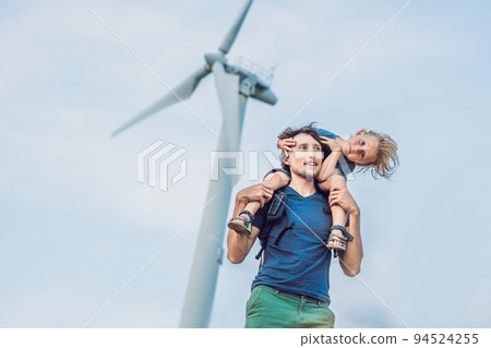 Father carrying son on shoulders and waving their arms like a windmill 94524255