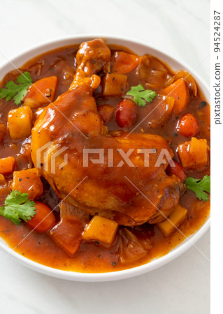 chicken stew with tomatoes, onions, carrot and potatoes 94524287
