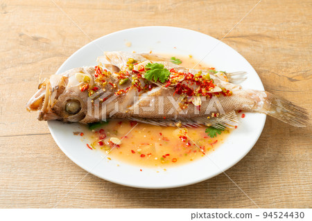 Steamed grouper fish with lime and chillies Steamed grouper fish with lime and chillies 94524430