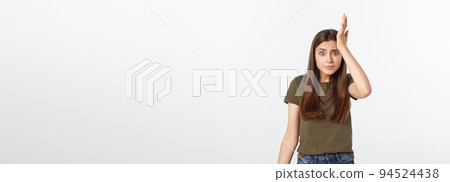 Girl with a suspicious look and hand on her side on a white isolated background. 94524438