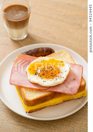 bread toasted cheese topped ham and fried egg with pork sausage 94524445