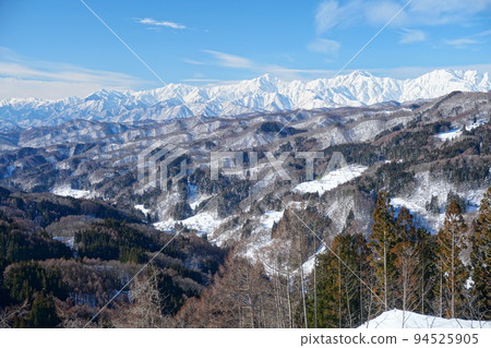 A large panorama of the silvery Northern Alps seen from Daibo Pass with the blue sky in the background Ver2 94525905