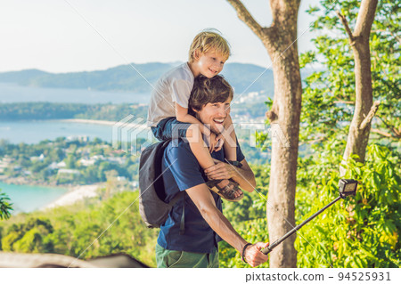 Father and son on Karon View Point in sunny day. Phuket Father and son on Karon View Point in sunny day. Phuket 94525931