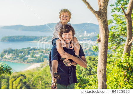 Father and son on Karon View Point in sunny day. Phuket Father and son on Karon View Point in sunny day. Phuket 94525933