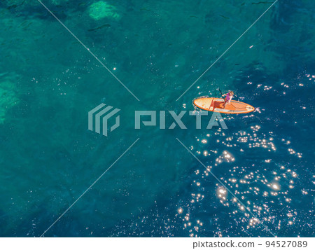 Young women Having Fun Stand Up Paddling in blue water sea in Montenegro. SUP. girl Training on Paddle Board near the rocks Portrait of a disgruntled girl sitting at a cafe table Young women Having Fun Stand Up Paddling in blue water sea in Montenegro. SUP. girl Training on Paddle Board near the rocks Portrait of a disgruntled girl sitting at a cafe table 94527089