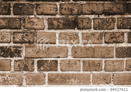 Faded old red brick wall, wide rough vintage texture. Dirty 94527411