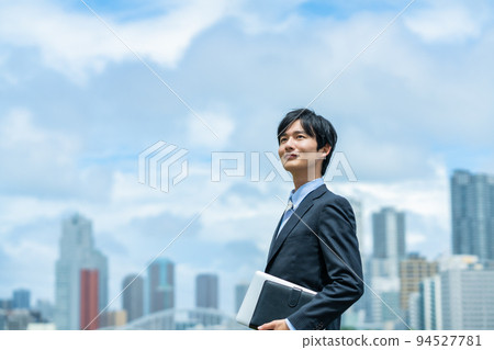 A young businessman doing business outside A young businessman doing business outside 94527781