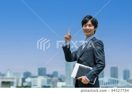 A young businessman doing business outside A young businessman doing business outside 94527784