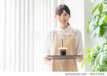 Image of a woman working in a cafe Image of a woman working in a cafe 94527938
