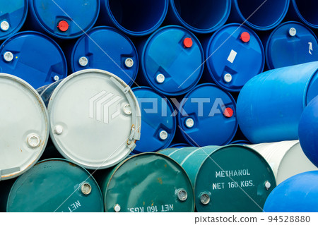 Old chemical barrels. Stack of blue methanol or methyl alcohol drum. Steel chemical tank. Toxic waste. Chemical barrel with toxic warning symbol. Industrial waste in drum. Hazard waste storage. 94528880