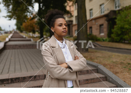 young successful black woman entrepreneur in business clothes on the background of the city stairs 94528887