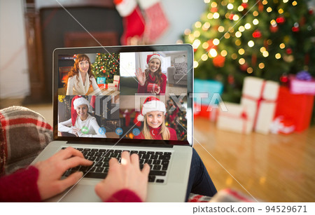 Caucasian woman on christmas laptop video call with diverse group of friends Caucasian woman on christmas laptop video call with diverse group of friends 94529671