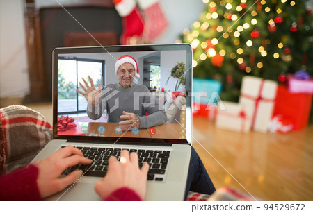 Caucasian woman on christmas laptop video call with caucasian man 94529672