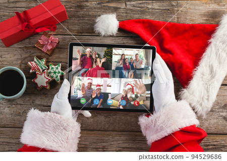 Santa claus on christmas laptop video call with diverse group of friends 94529686