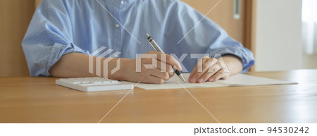 Woman using calculator at home. Household budget, payments, payments, budgets, loans, calculations, etc. Woman using calculator at home. Household budget, payments, payments, budgets, loans, calculations, etc. 94530242