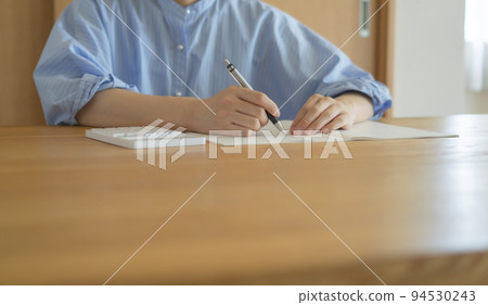 Woman using calculator at home. Household budget, payments, payments, budgets, loans, calculations, etc. Woman using calculator at home. Household budget, payments, payments, budgets, loans, calculations, etc. 94530243