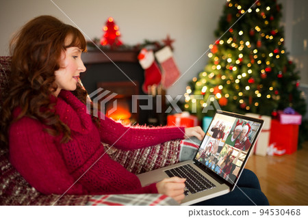 Caucasian woman on christmas laptop video call with diverse group of friends Caucasian woman on christmas laptop video call with diverse group of friends 94530468
