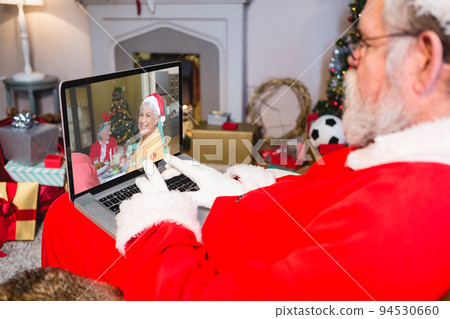 Caucasian santa claus on christmas laptop video call with caucasian woman Caucasian santa claus on christmas laptop video call with caucasian woman 94530660