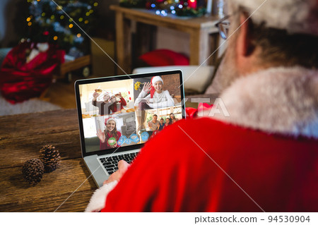 Caucasian santa claus on christmas laptop video call with diverse group of friends Caucasian santa claus on christmas laptop video call with diverse group of friends 94530904