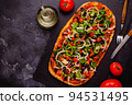 Homemade vegan pizza with tomatoes, peppers, olives, onions and herbs. 94531495