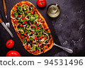Homemade vegan pizza with tomatoes, peppers, olives, onions and herbs. 94531496