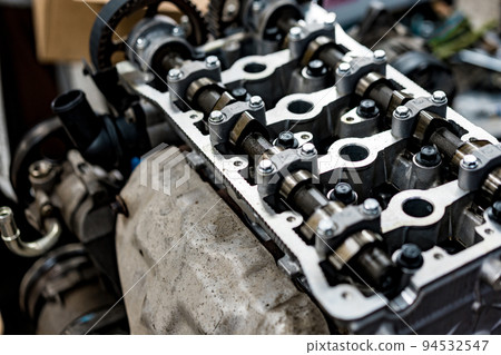 Disassembled car engine block at car service station Disassembled car engine block at car service station 94532547