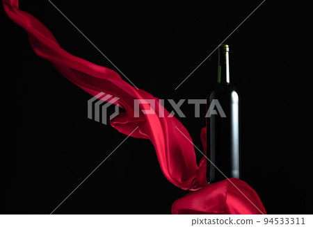 Bottle of red wine on a black background. 94533311