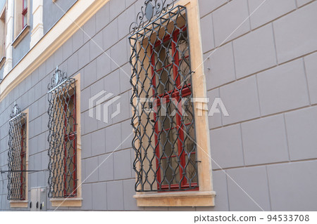 There are bars on the windows of the building. Penetration protection. Security and protection. 94533708