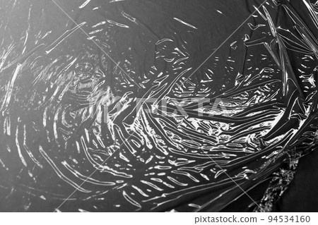 Reflecting light and shadow on creases and folds in plastic sheeting Reflecting light and shadow on creases and folds in plastic sheeting 94534160