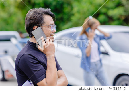 car crash accident man and women calling insurance agency for help 94534542