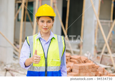 Women engineer worker foreman builder work in construction site portrait happy thumbs up for like and confirm pose. Women engineer worker foreman builder work in construction site portrait happy thumbs up for like and confirm pose. 94534730