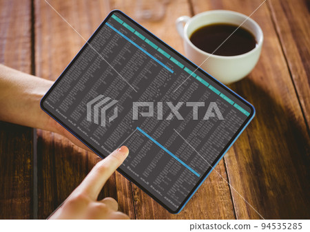 Hands of caucasian female programmer with coffee using tablet with coding on screen Hands of caucasian female programmer with coffee using tablet with coding on screen 94535285