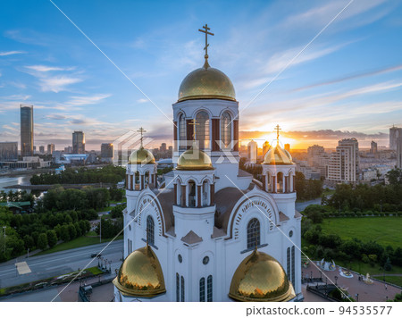 Summer Yekaterinburg and Temple on Blood in cloudy sunset. Aerial view of Yekaterinburg, Russia. Translation of the text on the temple 94535577