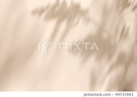 Shadow of delicate grass leaves on solid beige wall texture background Shadow of delicate grass leaves on solid beige wall texture background 94535661