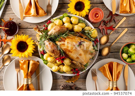 Overhead view of thanksgiving table with roast turkey, potatoes, candles and autumn decoration 94537074