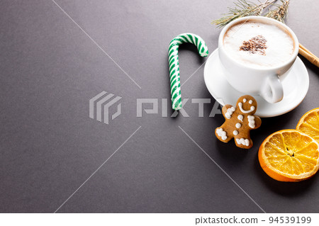 Image of cup of cappuccino coffee and christmas gingerbread man with copy space on grey Image of cup of cappuccino coffee and christmas gingerbread man with copy space on grey 94539199