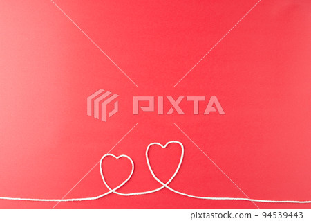 Image of hearts made of white string on red surface Image of hearts made of white string on red surface 94539443