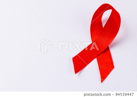 Image of red ribbon lying on white surface 94539447