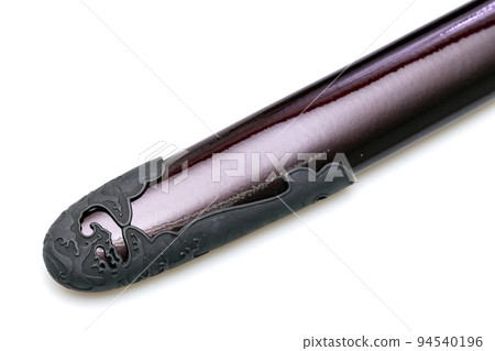 'Kojiri' is the end of the Japanese sword's scabbard or the protective fitting at the end of the scabbard. Normally made by horn but in this picture is metal. Isolated in white Background. 'Kojiri' is the end of the Japanese sword's scabbard or the protective fitting at the end of the scabbard. Normally made by horn but in this picture is metal. Isolated in white Background. 94540196