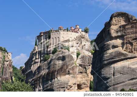 Rising high above the Thessalian plain, the sandstone megalith on which the Varlaam monastery 94540901